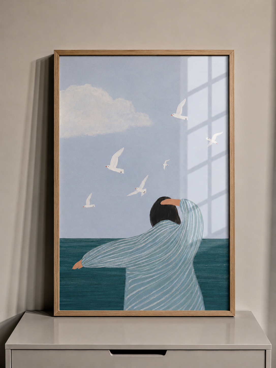 Blue coastal framed wall art with sea view and white birds